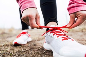 Woman runner tying sport shoes